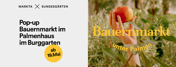 Pop-up-Bauernmarkt im Palmenhaus im Burggarten ab 19. Mai: Eine Hand mit Apfel ragt aus den Pflanzen im Palmenhaus.